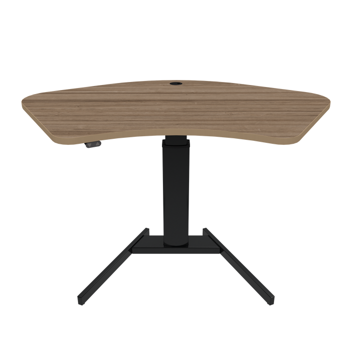 ConSet brand stand-up desk featuring a walnut wood finish tabletop with an ergonomic curve design, supported by a single, sturdy black steel column and a T-shaped base.