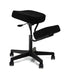 Black kneeling chair designed for ergonomic seating. The chair features a padded seat and knee rest for enhanced comfort, a black steel frame with a gas lift function for adjustable height, and casters for easy mobility. Ideal for promoting better posture and reducing back pain while working.