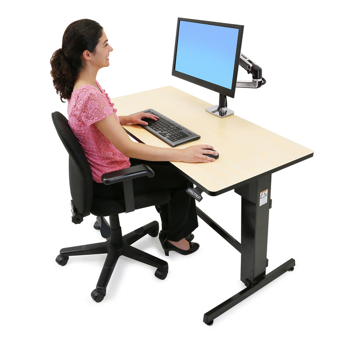 Ergotron WorkFit-D Sit-Stand Desk Birch with person seated at a computer