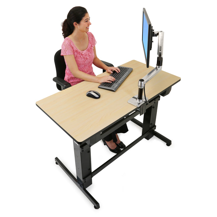 Ergotron WorkFit-D Sit-Stand Desk Birch with person seated at computer front side
